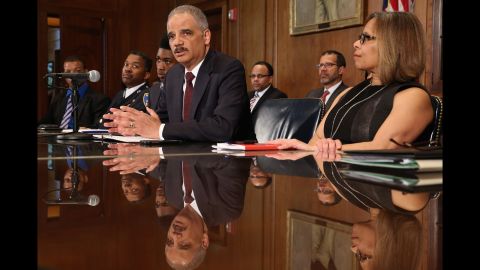 Holder delivers remarks about the shooting of two police officers in Ferguson, Missouri, at the Department of Justice in Washington on Thursday, March 12.