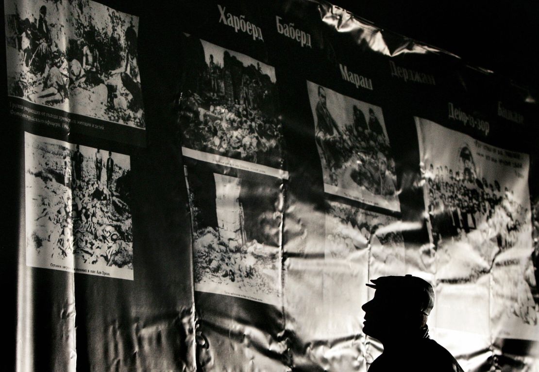 Armenians living in Moscow view photographs of Armenian victims of mass killings by Ottoman Turks during a memorial on 23 April, 2005, at the building site of a new Armenian Cathedral in Moscow.