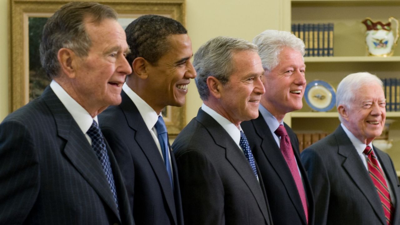 Then-President George W. Bush, center, stands with President-elect Barack Obama, second left, former President George H.W. Bush third left, former President Bill Clinton, second right and former President Jimmy Carter, right, in the Oval Office of the White House in Washington, D.C., on January 7, 2009. 