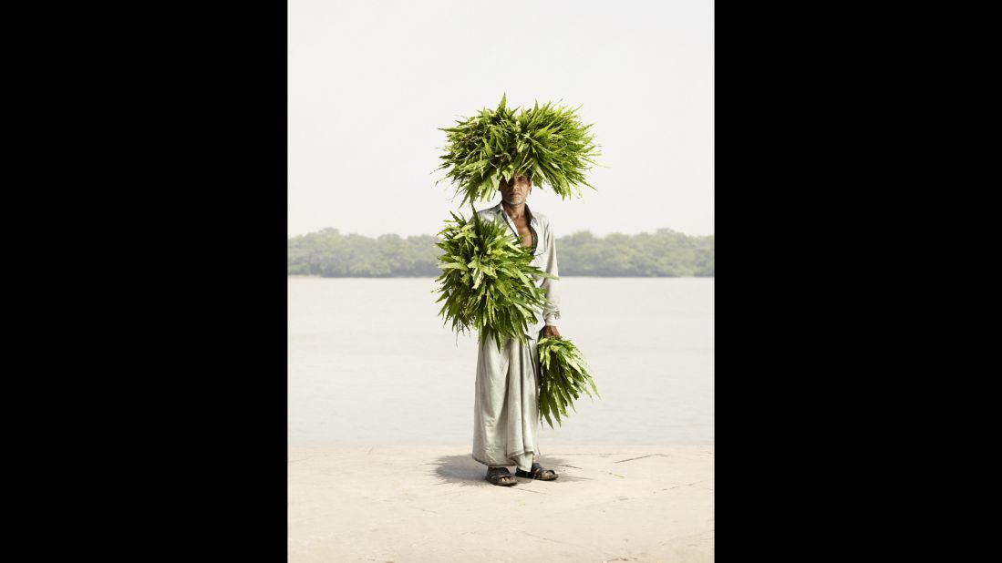 The abundant leaves come to life in Odhir Gayen's portrait. "These are a special kind of leaves, and many of (the sellers) carry them on their head and (on their) arms," Hermann said. "And when they walk around, it's almost like a human bush or something like that."​