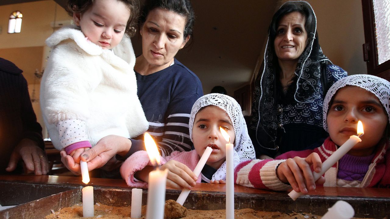 Assyrian Christian women and their daughters, refugees from the unrest in Syria, attend a prayer service at a Lebanese church northeast of Beirut. The service was for 220 Assyrian Christians abducted from their villages in northeastern Syria by Islamic State militants.