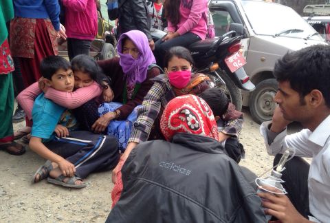 People huddle together outside a hospital in Kathmandu. Eyewitnesses said residents were scared and waiting for aftershocks to end.