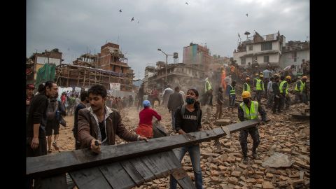 Rescue workers clear debris in Kathmandu while searching for survivors.