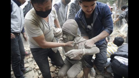 People free a man from the rubble of a destroyed building in Kathmandu.