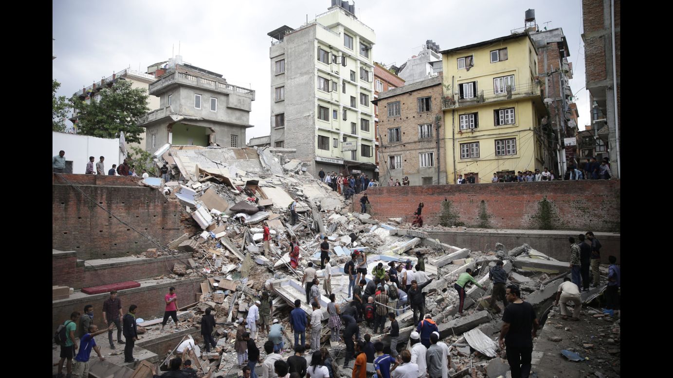 People search for survivors stuck under the rubble of a destroyed building in Kathmandu.