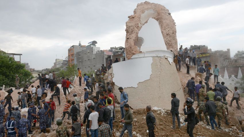 Nepalese rescue members gather at the collapsed Darahara Tower in Kathmandu on April 25, 2015. A powerful 7.9 magnitude earthquake struck Nepal, causing massive damage in the capital Kathmandu with strong tremors felt across neighbouring countries. AFP PHOTO / PRAKASH MATHEMA (Photo credit should read PRAKASH MATHEMA/AFP/Getty Images)