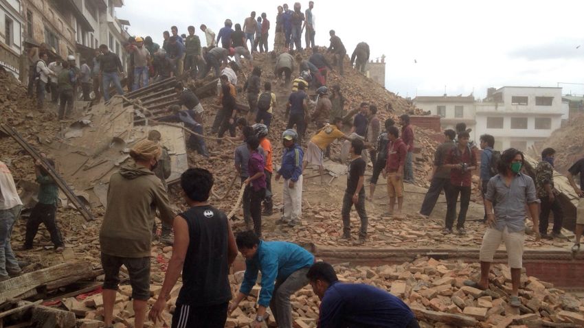 Volunteers help with rescue work at the site of a building that collapsed after an earthquake in Kathmandu, Nepal, Saturday, April 25, 2015. A strong magnitude-7.9 earthquake shook Nepal's capital and the densely populated Kathmandu Valley before noon Saturday, causing extensive damage with toppled walls and collapsed buildings, officials said. (AP Photo/ Niranjan Shrestha)