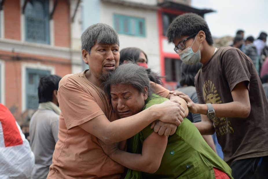 A Nepalese man and woman hold each other in Kathmandu's Basantapur Durbar Square on April 25.