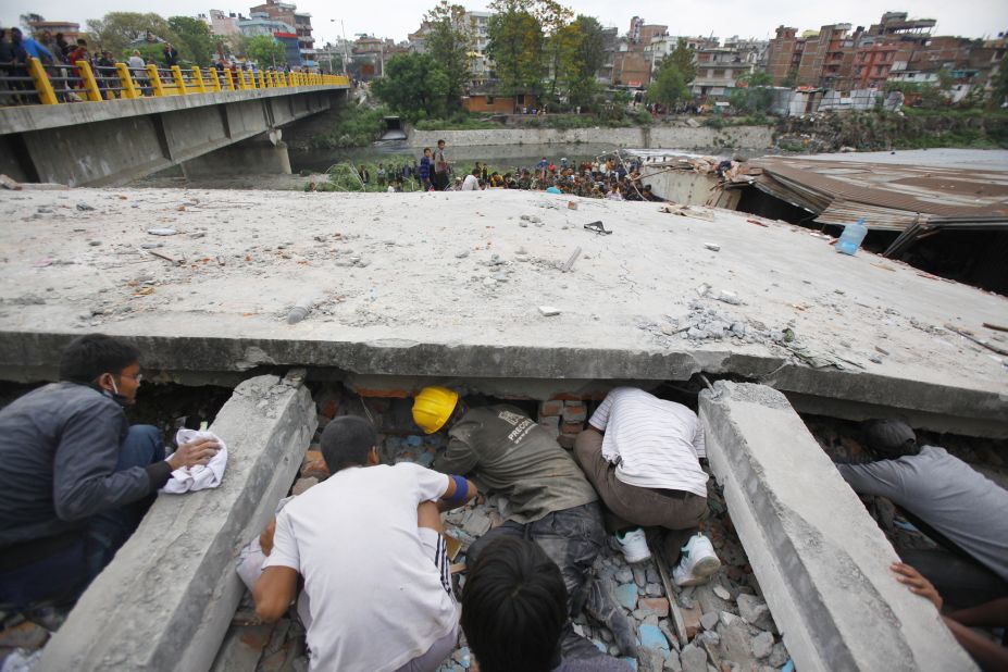 Rescuers look for victims under a collapsed building in Kathmandu on April 25. 