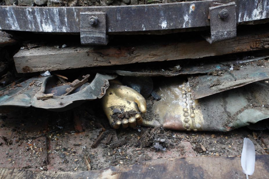 The hand of a statue is seen under debris in Basantapur Durbar Square in Kathmandu.