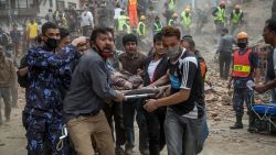 Caption:KATHMANDU, NEPAL - APRIL 25: Emergency rescue workers carry a victim on a stretcher after Dharara tower collapsed on April 25, 2015 in Kathmandu, Nepal. More than 100 people have died as tremors hit Nepal after an earthquake measuring 7.9 on the Richter scale caused buildings to collapse and avalanches to be triggered in the Himalayas. Authorities have warned that the death toll is likely to be much higher. (Photo by Omar Havana/Getty Images)