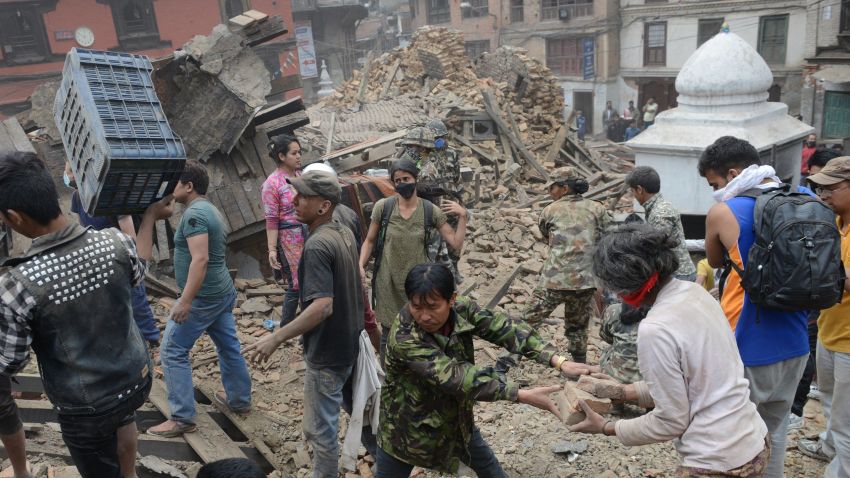 People clear rubble in Kathmandu's Durbar Square on Saturday, April 25.