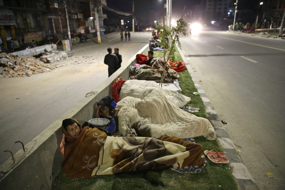 People sleep on a street in Kathmandu, Nepal, on Saturday, April 25. A seemingly endless series of aftershocks continued to roil the area, further traumatizing survivors. 