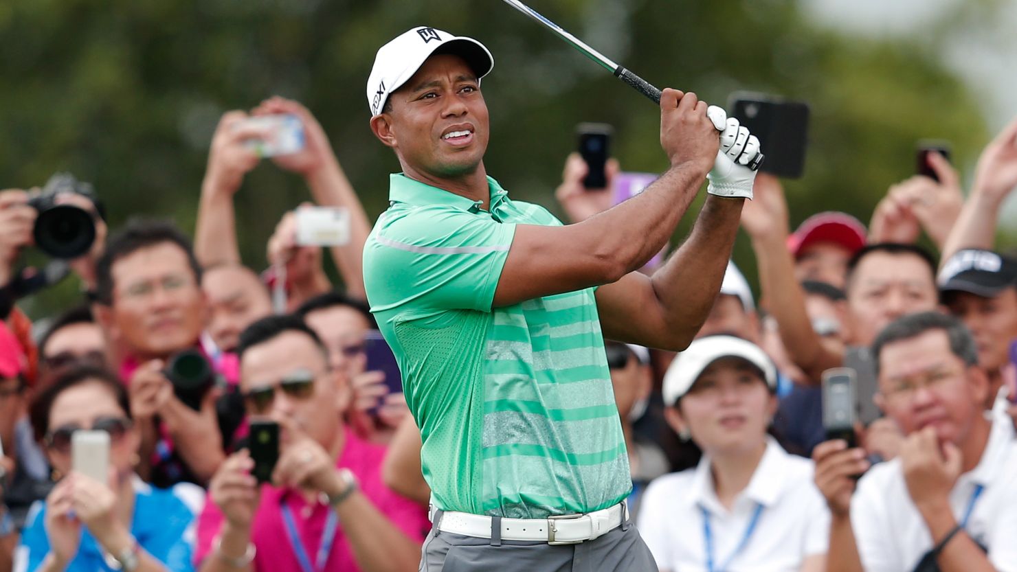 Tiger Woods playing at a 2013 exhibition in China, where he met NBA star Yao Ming on Friday. 