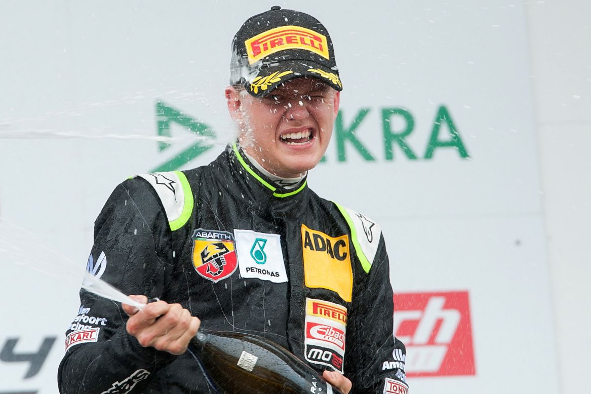Mick Schumacher celebrates after winning the trophy for the best rookie in the opening race of the new ADAC Formula Four championship.