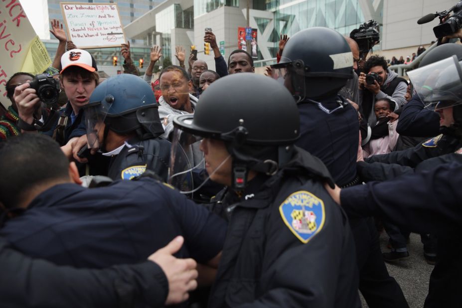 Protesters get into a shoving match with police during a march downtown on April 25.