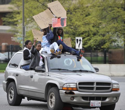 Protesters drive through the Camden Yards area on April 25. 