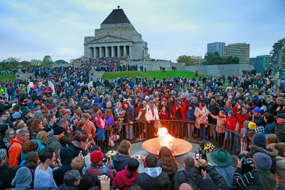 A large crowd gathers around the eternal flame for the 2015 dawn service on Anzac Day at the Shrine of Remembrance in Melbourne, Australia. 