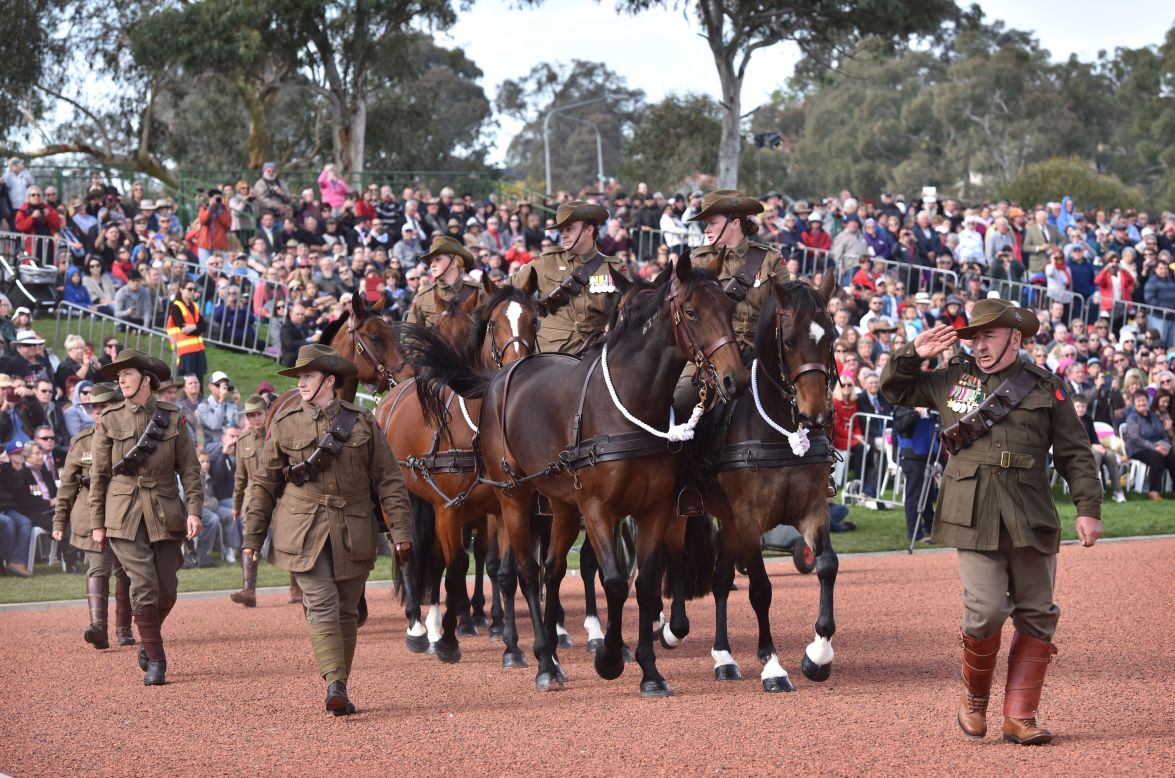 Servicemen and women march wearing period uniforms at the Australian War Memorial in Canberra, Australia. 