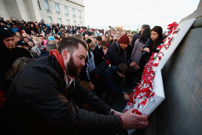 People pin poppies to the Cenotaph following the dawn service at the Auckland War Memorial Museum  in Auckland, New Zealand. 