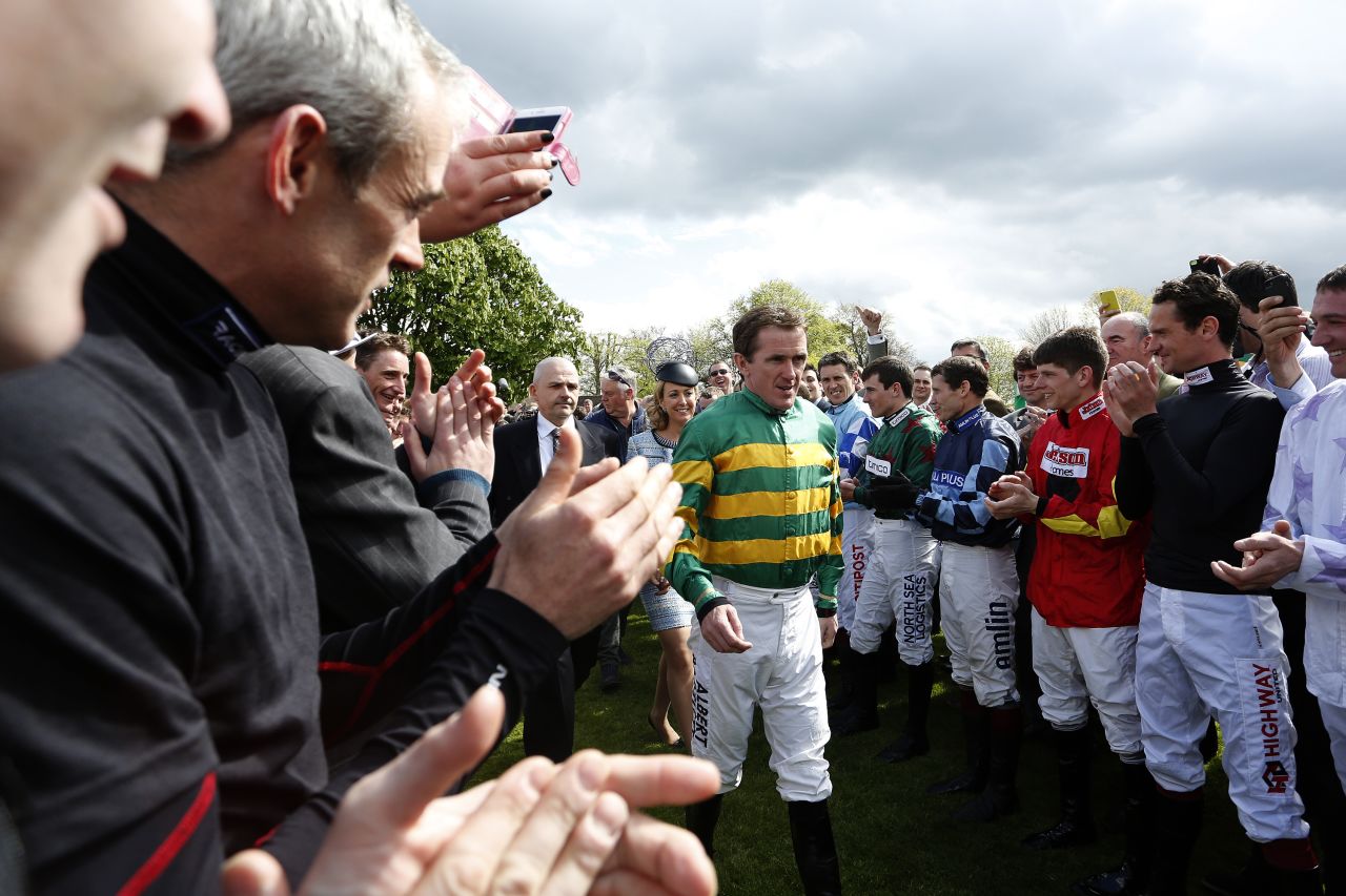 McCoy, who won 4,382 races <a href="https://www.cnn.com/2015/02/10/horseracing/ap-mccoy-horse-racing-retirement/index.html" target="_blank">and broke just about every bone in his body</a>, was cheered into the parade ring by his fellow jockeys.  