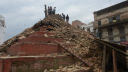 Caption:People gather in Kathmandu's Durbar Square, a UNESCO World Heritage Site that was severely damaged by an earthquake on April 25, 2015. A massive 7.8 magnitude earthquake killed hundreds of people April 25 as it ripped through large parts of Nepal, toppling office blocks and towers in Kathmandu and triggering a deadly avalanche that hit Everest base camp. AFP PHOTO / PRAKASH MATHEMA (Photo credit should read PRAKASH MATHEMA/AFP/Getty Images)