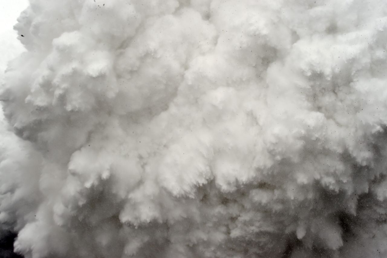 A cloud of snow and debris triggered by an earthquake flies toward Everest base camp on Saturday, April 25. The avalanche flattened part of the camp in the Himalayas.