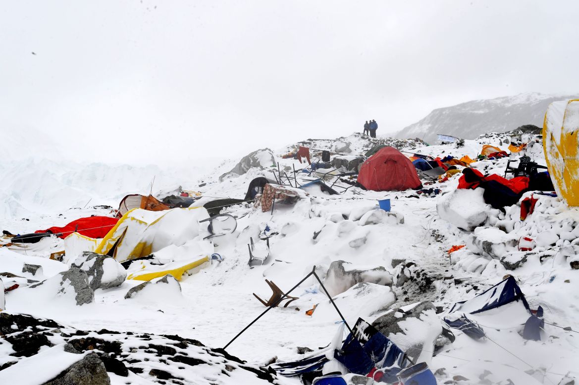 People look at the devastation on April 25 after the avalanche.