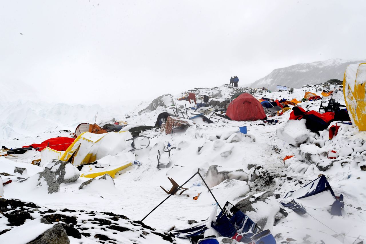 People look at the devastation on April 25 after the avalanche.