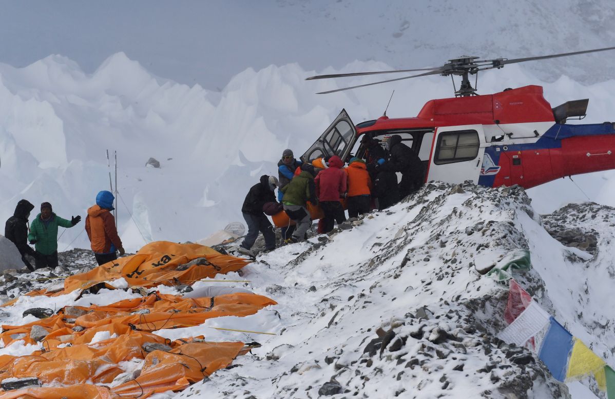 An injured person is loaded onto a rescue helicopter on Sunday, April 26, at Everest base camp. The bodies of those who died lie under orange tents. <a href="http://www.cnn.com/2015/04/26/asia/nepal-earthquake/index.html">The devastating earthquake that hit Nepal on Saturday</a> set off avalanches that left large numbers of climbers dead, missing, injured or trapped on Mount Everest.