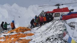 Caption:An injured person is loaded onto a rescue helicopter at Everest Base Camp on April 26, 2015, a day after an avalanche triggered by an earthquake devastated the camp. Rescuers in Nepal are searching frantically for survivors of a huge quake on April 25, that killed nearly 2,000, digging through rubble in the devastated capital Kathmandu and airlifting victims of an avalanche at Everest base Camp. The bodies of those who perished lie under orange tents. AFP PHOTO/ROBERTO SCHMIDT (Photo credit should read ROBERTO SCHMIDT/AFP/Getty Images)