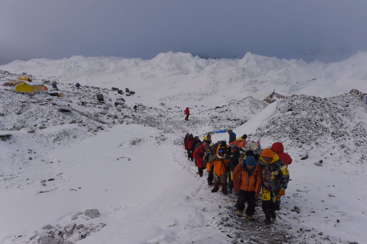 An injured person is carried by rescuers on April 26 to be airlifted by helicopter at Everest base camp. 