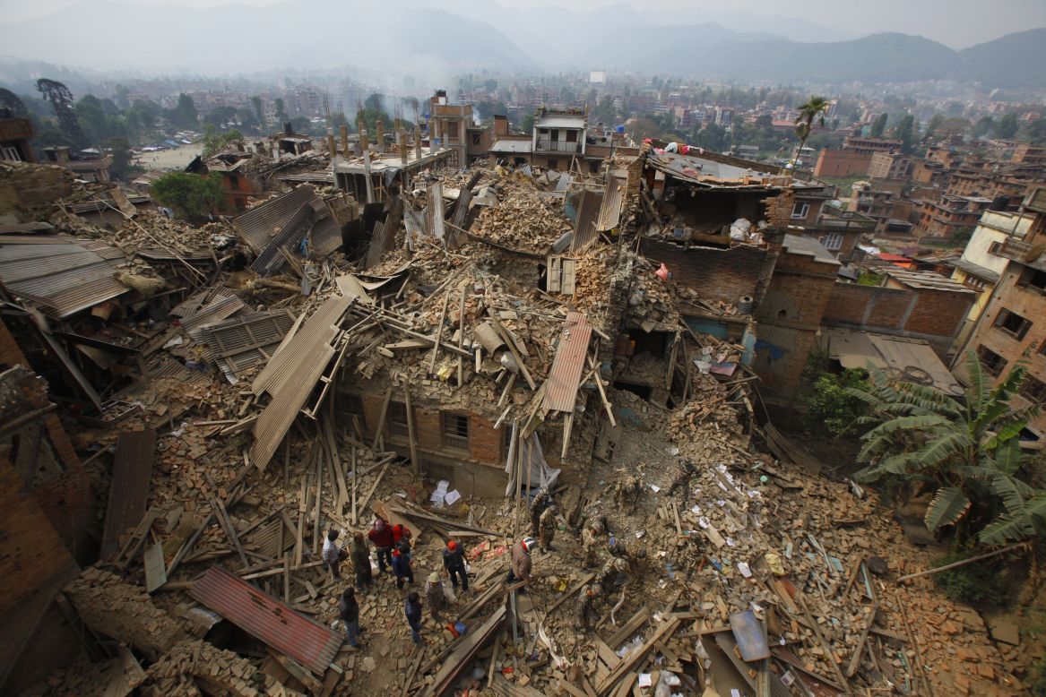 Rescue workers remove debris on April 26 as they search for victims in Bhaktapur.