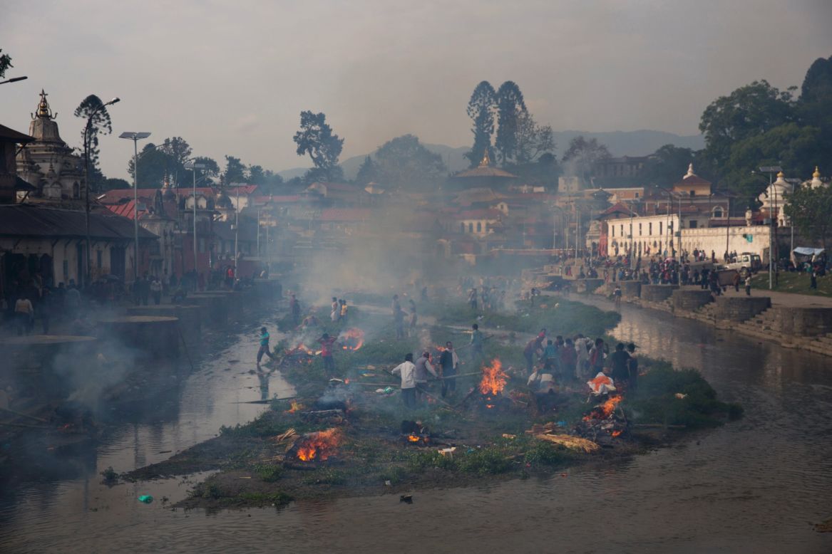 Smoke from funeral pyres fills the air at the Pashupatinath temple on the banks of Bagmati River in Kathmandu on April 26.