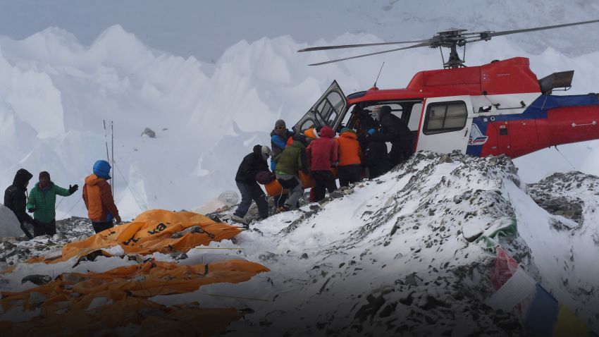 An injured person is loaded onto a rescue helicopter at Everest Base Camp on April 26, 2015, a day after an avalanche triggered by an earthquake devastated the camp. Rescuers in Nepal are searching frantically for survivors of a huge quake on April 25, that killed nearly 2,000, digging through rubble in the devastated capital Kathmandu and airlifting victims of an avalanche at Everest base Camp. The bodies of those who perished lie under orange tents. AFP PHOTO/ROBERTO SCHMIDT (Photo credit should read ROBERTO SCHMIDT/AFP/Getty Images)