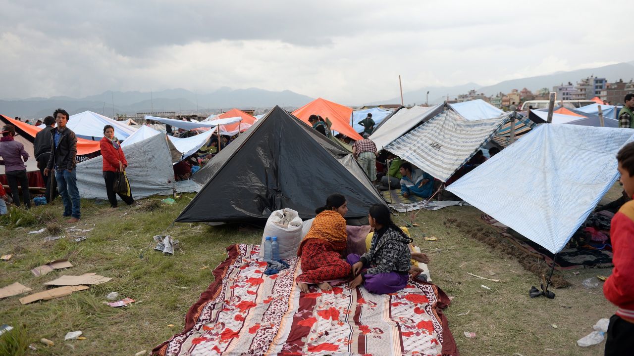 Nepalese people stay outside in tents on the outskirts of Kathmandu.