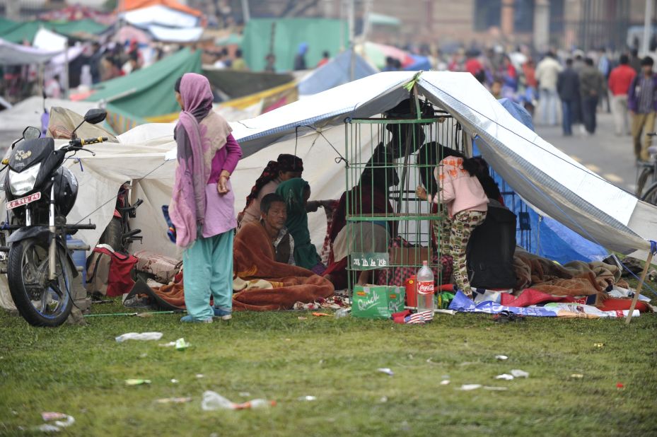 People rest in temporary shelters in Kathmandu on April 27.