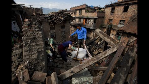 A family collects belongings from their home in Bhaktapur, Nepal, on Monday, April 27. 