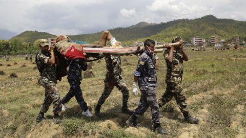 Emergency personnel evacuate an injured man to a waiting helicopter in Trishuli Bazar on April 27.