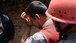 A Nepalese resident reacts as police retrieve the body of his relative Prasamsah, 14, during rescue efforts in Balaju in Kathmandu on April 27, 2015. International aid groups and governments intensified efforts to get rescuers and supplies into earthquake-hit Nepal on April 26, 2015, but severed communications and landslides in the Himalayan nation posed formidable challenges to the relief effort. As the death toll surpassed 2,000, the US together with several European and Asian nations sent emergency crews to reinforce those scrambling to find survivors in the devastated capital Kathmandu and in rural areas cut off by blocked roads and patchy phone networks. AFP PHOTO/PRAKASH SINGH        (Photo credit should read PRAKASH SINGH/AFP/Getty Images)