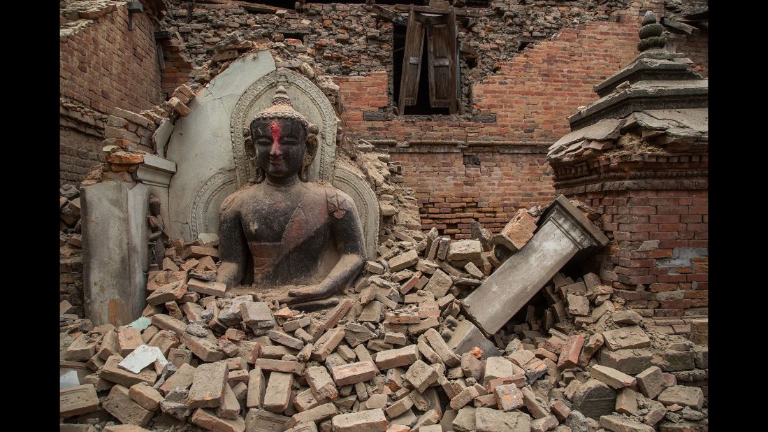 A Buddha statue is surrounded by debris on April 26 from a collapsed temple in the UNESCO world heritage site of Bhaktapur.