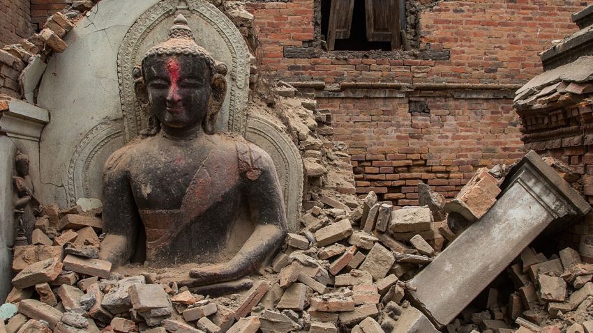 BHAKTAPUR, NEPAL - APRIL 26:  A Buddha statue is surrounded by debris from a collapsed temple in the UNESCO world heritage site of Bhaktapur on April 26, 2015 in Bhaktapur, Nepal. A major 7.8 earthquake hit Kathmandu mid-day on Saturday, and was followed by multiple aftershocks that triggered avalanches on Mt. Everest that buried mountain climbers in their base camps. Many houses, buildings and temples in the capital were destroyed during the earthquake, leaving thousands dead or trapped under the debris as emergency rescue workers attempt to clear debris and find survivors.  (Photo by Omar Havana/Getty Images)