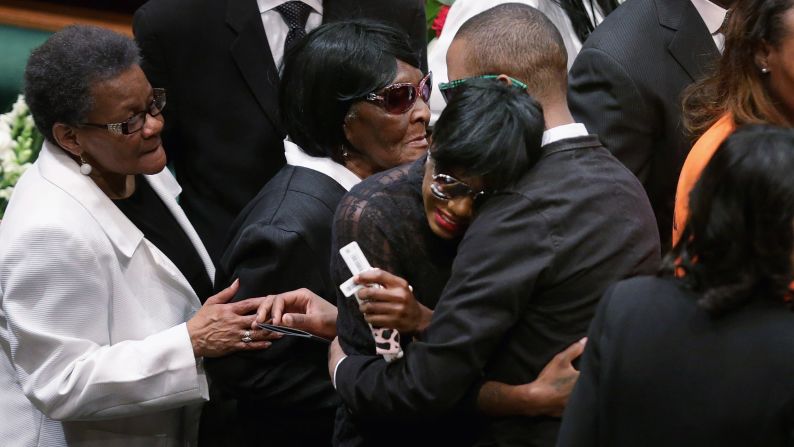 Gray's twin sister, Fredericka Gray, is embraced by family members and supporters during her brother's funeral.