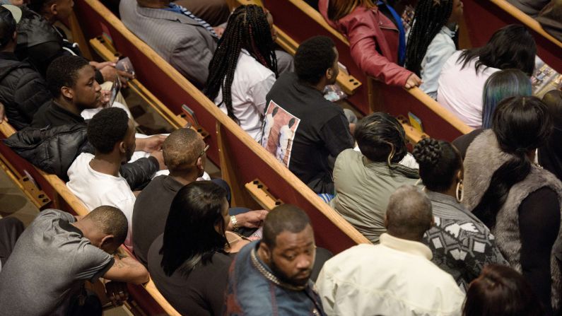 Mourners wait for the start of the funeral.