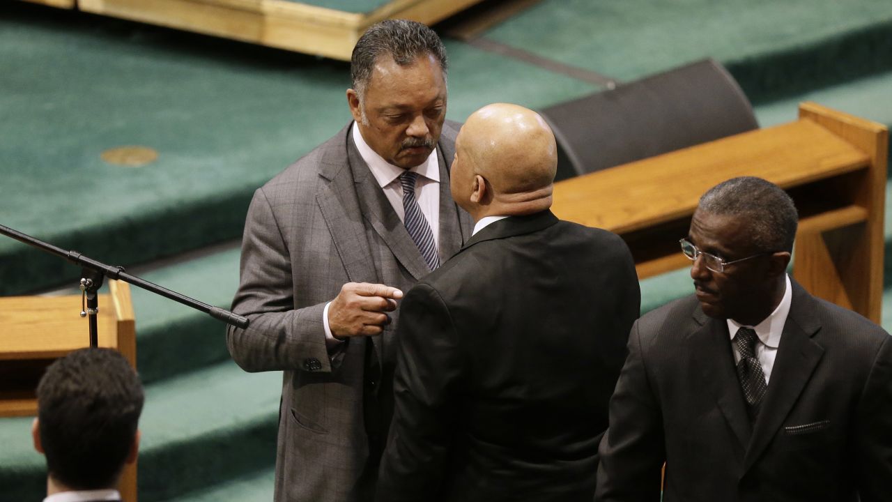 The Rev. Jesse Jackson, left, speaks with Rep. Elijah Cummings of Maryland before the start of the funeral.