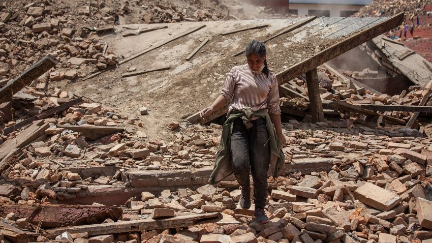 A volunteer walks on top of the debris of a collapsed temple at Basantapur Durbar Square on April 27, 2015 in Kathmandu, Nepal.