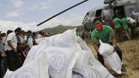 Volunteers unload relief material brought in by Indian air force helicopters for victims of a 7.8 magnitude earthquake in Nepal on April 27. 