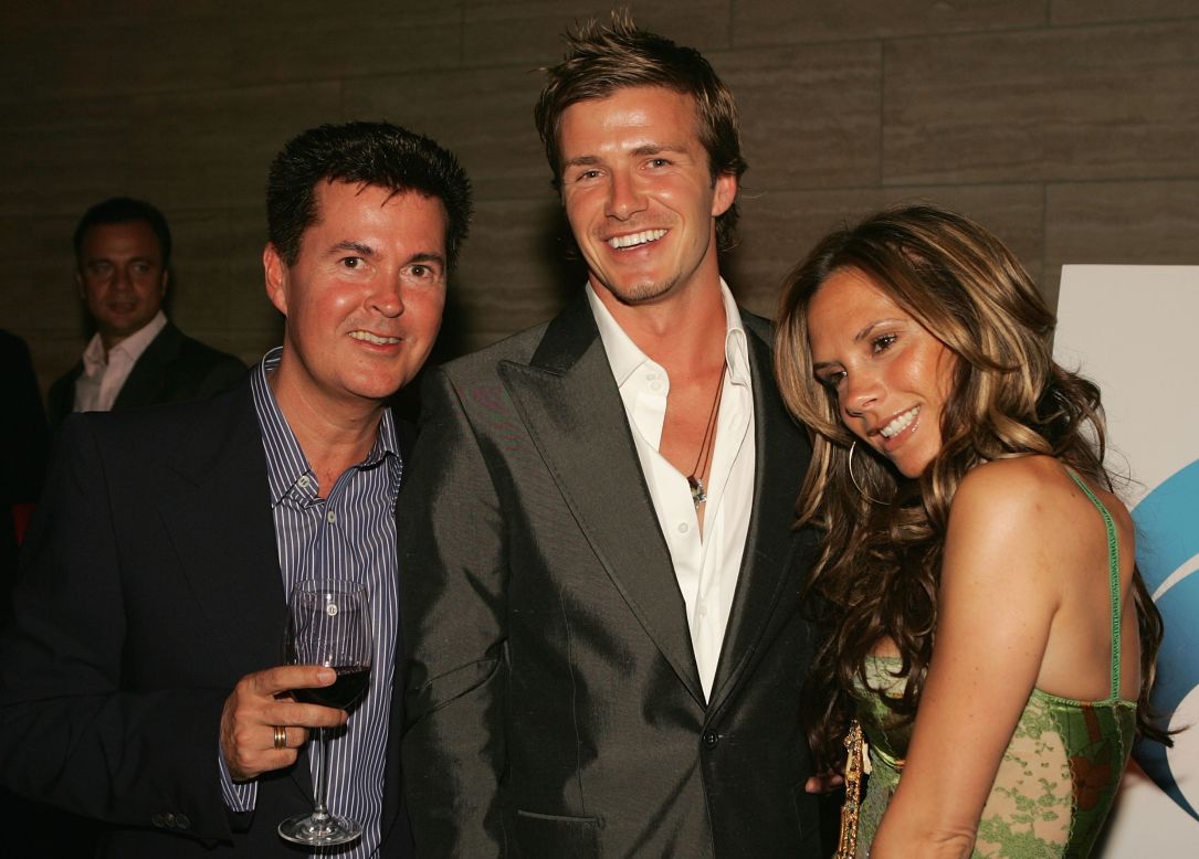 Here he is pictured with two of the people responsible for helping him become a global phenomenon, transcending his status as a football star: his wife Victoria (right) and "American Idol" creator Simon Fuller (left).  