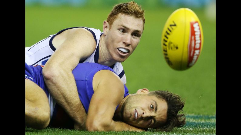 Tom Lynch of the Crows tackles Luke Dahlhaus of the Bulldogs in a rugby match on Sunday, April 26, in Melbourne.