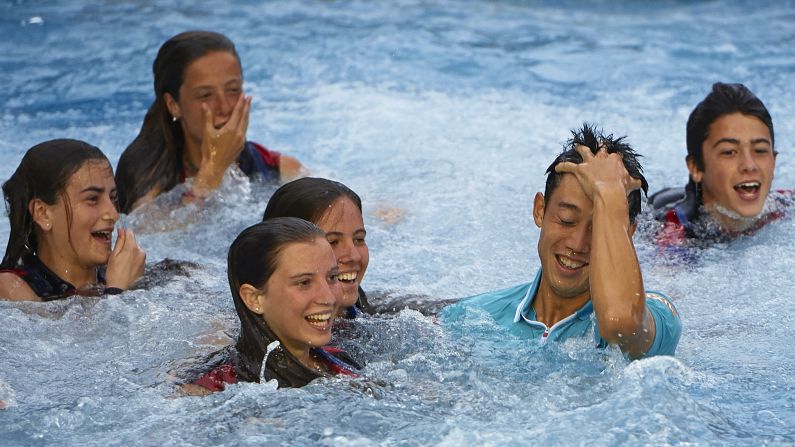 Tennis player Kei Nishikori of Japan jumps into the pool after his victory against Pablo Andujar of Spain, on Sunday, April 26, in Barcelona, Spain.